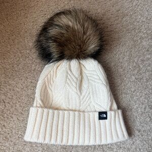 The North Face Ivory Cable Knit Beanie with Faux Fur Pom